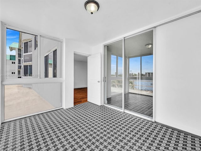 1170 NE 191st St Unit 24, Miami, FL 33179 - unfurnished room with a water view and carpet
