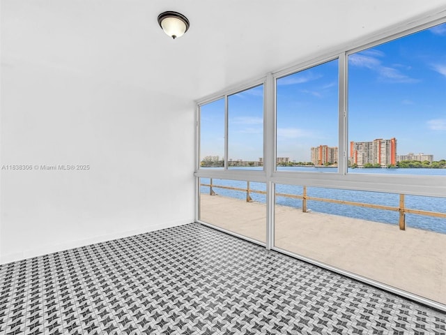 1170 NE 191st St Unit 24, Miami, FL 33179 - unfurnished sunroom featuring a water view and a city view