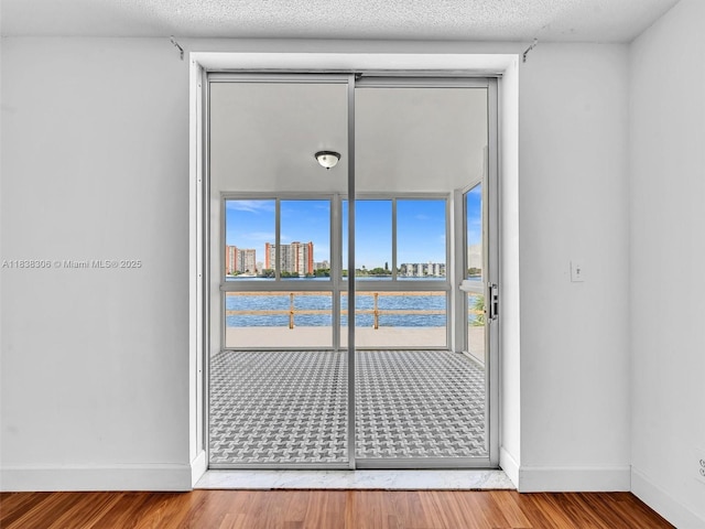 1170 NE 191st St Unit 24, Miami, FL 33179 - spare room with plenty of natural light, a water view, and wood finished floors