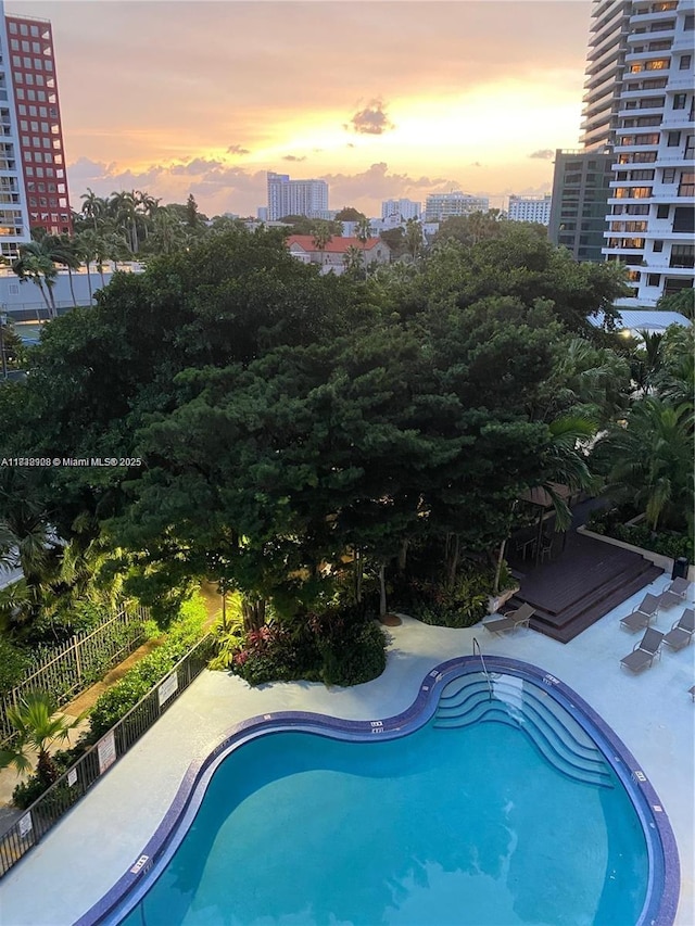 1450 Brickell Bay Dr Unit 1402, Miami, FL 33131 - pool at dusk featuring a view of city and a community pool