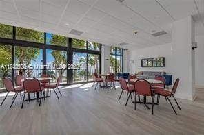 1450 Brickell Bay Dr Unit 1402, Miami, FL 33131 - dining area featuring wood finished floors and expansive windows