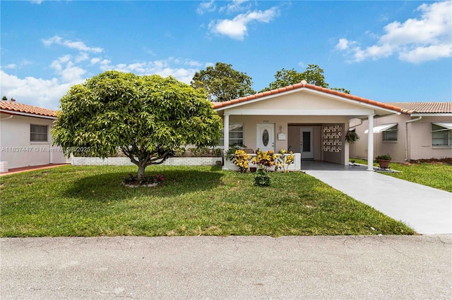 5723 NW 86th Ave, Tamarac, FL 33321 - view of front of property with concrete driveway, an attached carport, a front lawn, a tiled roof, and stucco siding