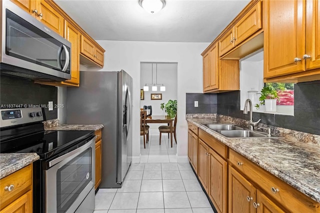 5723 NW 86th Ave, Tamarac, FL 33321 - kitchen with stainless steel appliances, tasteful backsplash, brown cabinets, and light tile patterned flooring