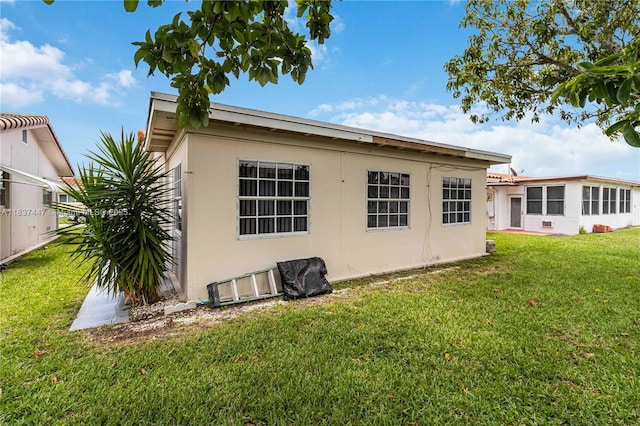 5723 NW 86th Ave, Tamarac, FL 33321 - rear view of house with stucco siding and a lawn