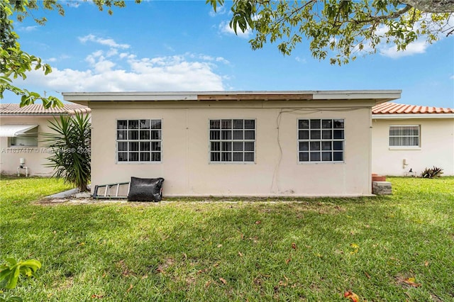 5723 NW 86th Ave, Tamarac, FL 33321 - rear view of house with stucco siding and a yard