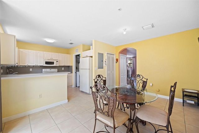 8079 W 36th Ave Unit 6, Hialeah, FL 33018 - dining area with arched walkways, electric panel, and light tile patterned flooring