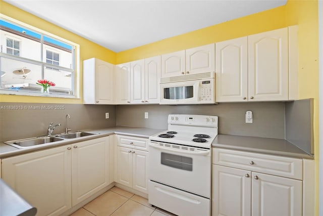 8079 W 36th Ave Unit 6, Hialeah, FL 33018 - kitchen with white appliances, white cabinetry, and light tile patterned flooring