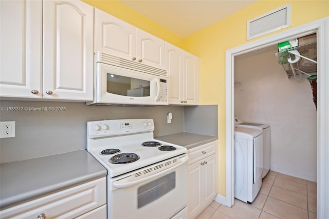 8079 W 36th Ave Unit 6, Hialeah, FL 33018 - kitchen featuring white appliances, light tile patterned floors, independent washer and dryer, and white cabinets