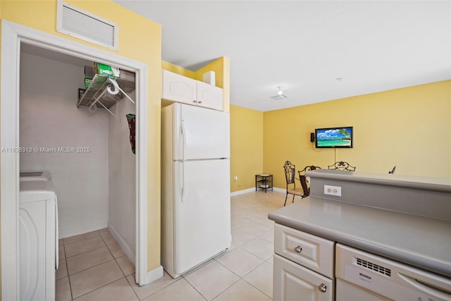 8079 W 36th Ave Unit 6, Hialeah, FL 33018 - kitchen featuring white appliances, washer / dryer, light tile patterned floors, white cabinets, and light countertops