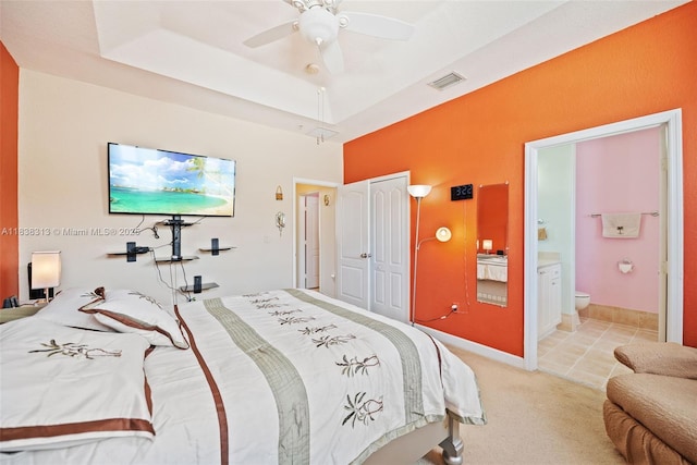 8079 W 36th Ave Unit 6, Hialeah, FL 33018 - bedroom featuring light colored carpet, ensuite bath, a closet, a tray ceiling, and ceiling fan
