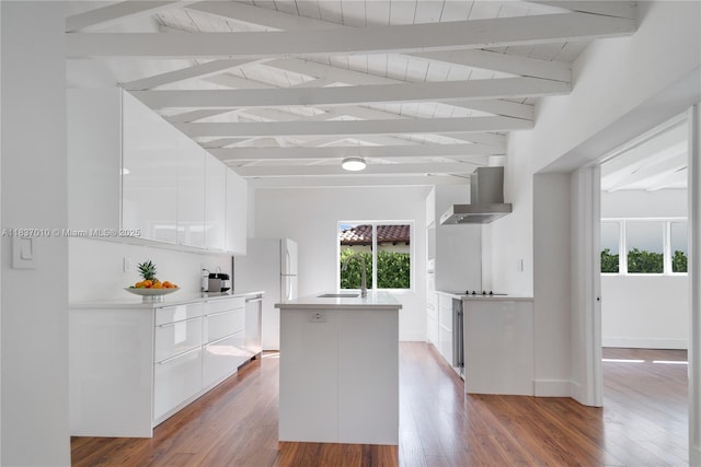 5308 Riviera Dr, Coral Gables, FL 33146 - kitchen with modern cabinets, wall chimney range hood, white cabinets, wood finished floors, and dishwasher
