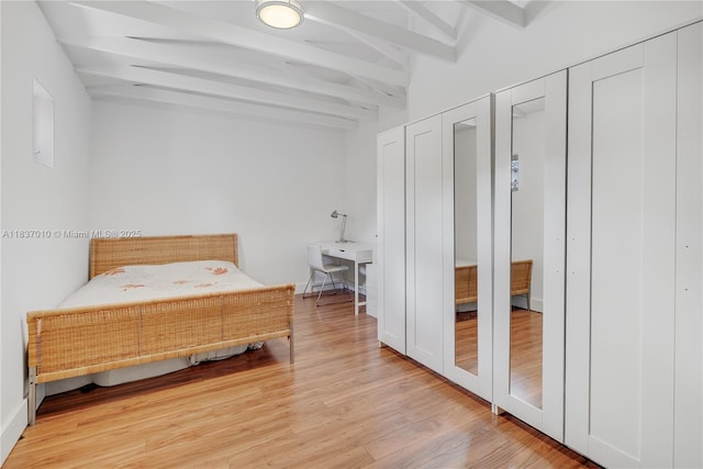 5308 Riviera Dr, Coral Gables, FL 33146 - bedroom with beamed ceiling, light wood-style floors, and multiple closets