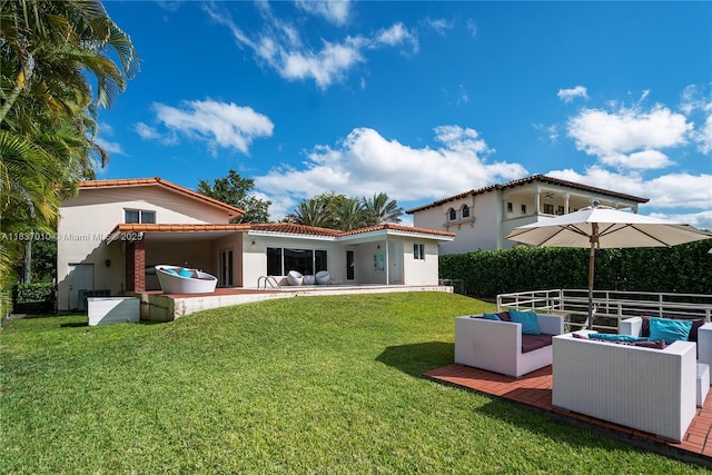 5308 Riviera Dr, Coral Gables, FL 33146 - back of house with outdoor lounge area, a tiled roof, stucco siding, a yard, and a patio area