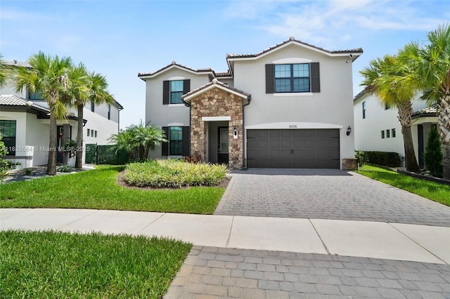 8036 NW 78th St, Tamarac, FL 33321 - view of front facade featuring stone siding, decorative driveway, stucco siding, an attached garage, and a tiled roof