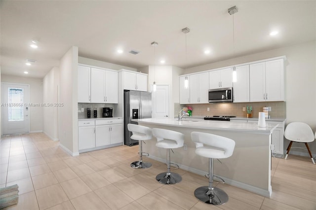 8036 NW 78th St, Tamarac, FL 33321 - kitchen featuring stainless steel appliances, tasteful backsplash, light countertops, a breakfast bar, and recessed lighting