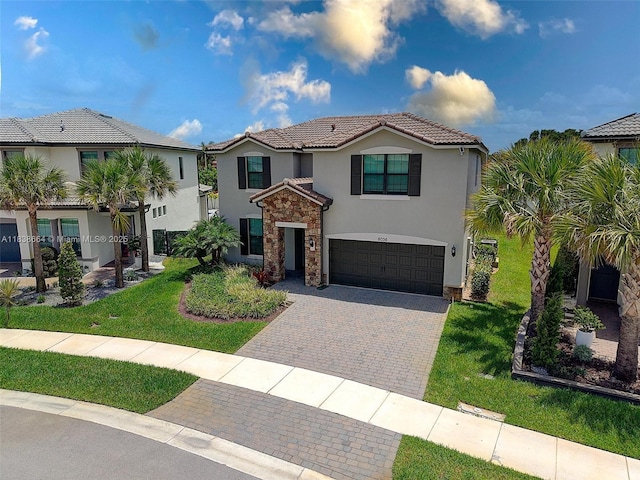8036 NW 78th St, Tamarac, FL 33321 - view of front of house with decorative driveway, a garage, stucco siding, and a tiled roof