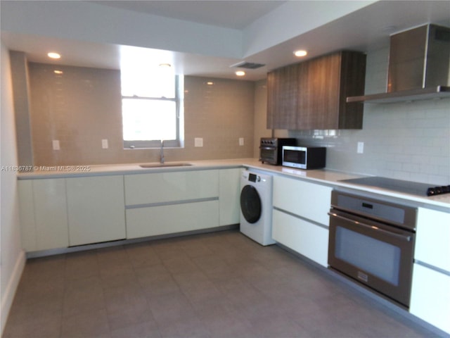 1025 92nd St Unit 804, Bay Harbor Islands, FL 33154 - kitchen with washer / clothes dryer, stainless steel appliances, wall chimney exhaust hood, light countertops, and modern cabinets