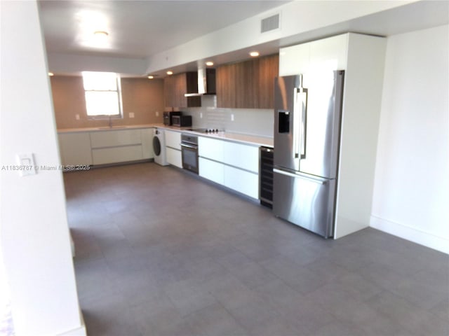 1025 92nd St Unit 804, Bay Harbor Islands, FL 33154 - kitchen featuring appliances with stainless steel finishes, washer / dryer, modern cabinets, wall chimney exhaust hood, and light countertops
