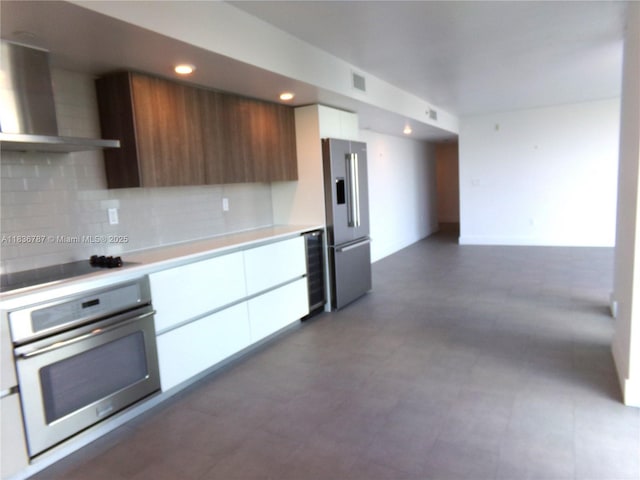 1025 92nd St Unit 804, Bay Harbor Islands, FL 33154 - kitchen featuring appliances with stainless steel finishes, wall chimney exhaust hood, modern cabinets, white cabinets, and recessed lighting
