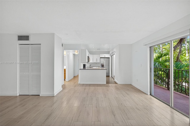 1821 Jefferson Ave Unit 202, Miami Beach, FL 33139 - unfurnished living room featuring light wood finished floors and baseboards