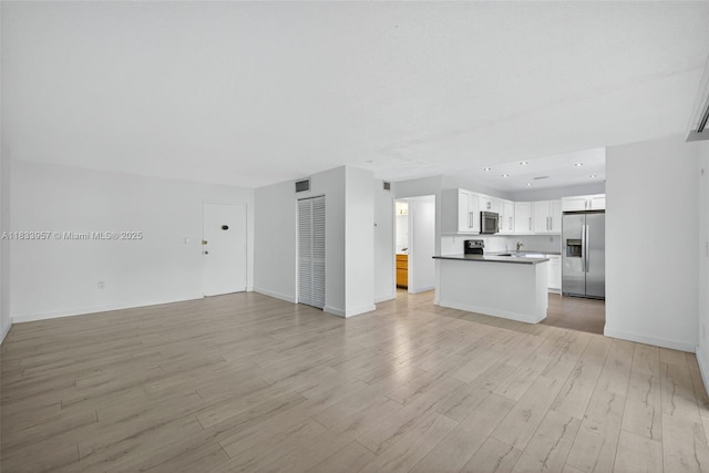1821 Jefferson Ave Unit 202, Miami Beach, FL 33139 - unfurnished living room with light wood-style floors and baseboards