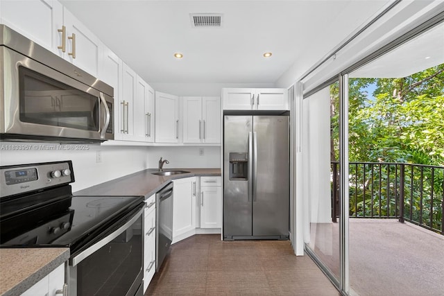 1821 Jefferson Ave Unit 202, Miami Beach, FL 33139 - kitchen featuring stainless steel appliances, white cabinetry, and recessed lighting
