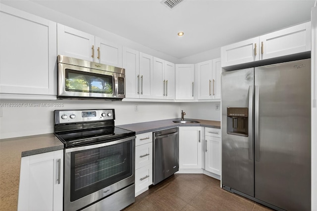 1821 Jefferson Ave Unit 202, Miami Beach, FL 33139 - kitchen featuring stainless steel appliances, white cabinetry, dark countertops, and recessed lighting