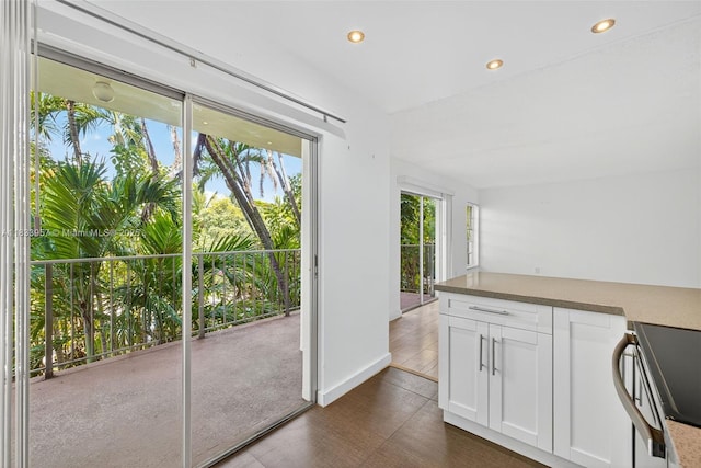 1821 Jefferson Ave Unit 202, Miami Beach, FL 33139 - kitchen featuring stainless steel range with electric stovetop, dark wood-style floors, white cabinets, and recessed lighting