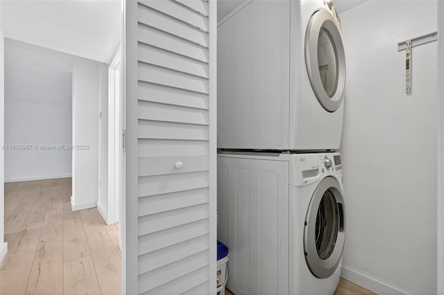 1821 Jefferson Ave Unit 202, Miami Beach, FL 33139 - laundry room featuring stacked washing machine and dryer and light wood-style floors