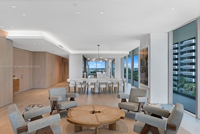 10203 Collins Ave Unit 701, Bal Harbour, FL 33154 - living area featuring a wall of windows, light wood finished floors, and a chandelier
