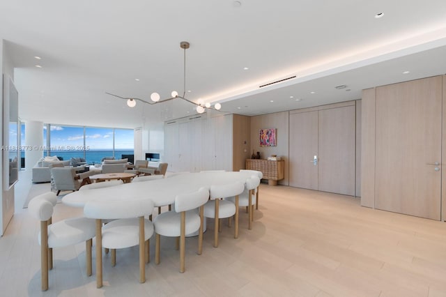 10203 Collins Ave Unit 701, Bal Harbour, FL 33154 - dining area featuring expansive windows and light wood-style flooring