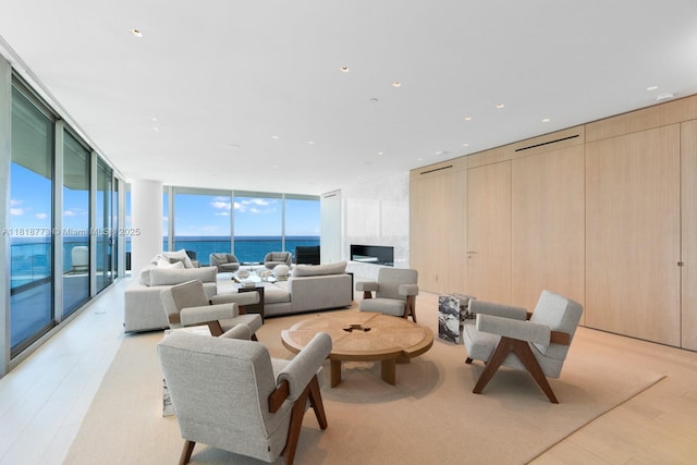 10203 Collins Ave Unit 701, Bal Harbour, FL 33154 - living room with expansive windows, light wood finished floors, and a water view