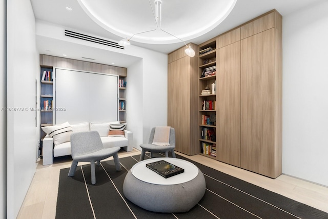 10203 Collins Ave Unit 701, Bal Harbour, FL 33154 - sitting room featuring built in features and a raised ceiling