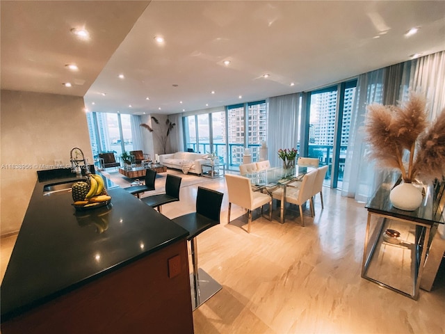 465 Brickell Ave Unit 1101, Miami, FL 33131 - kitchen featuring floor to ceiling windows, recessed lighting, dark countertops, and open floor plan