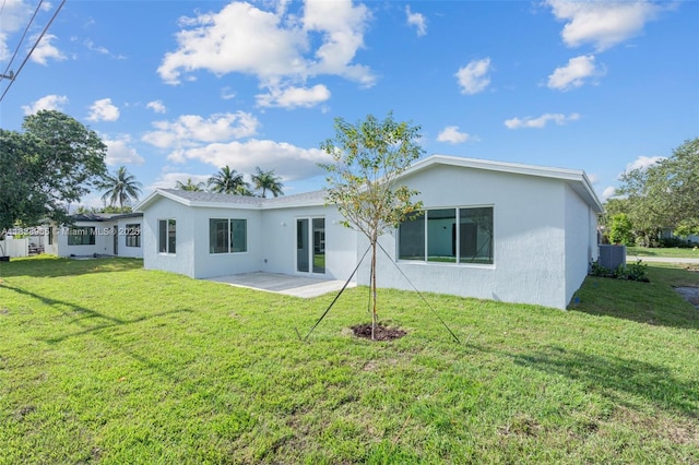 3451 SW 19th St, Fort Lauderdale, FL 33312 - rear view of house with a patio, stucco siding, and a yard
