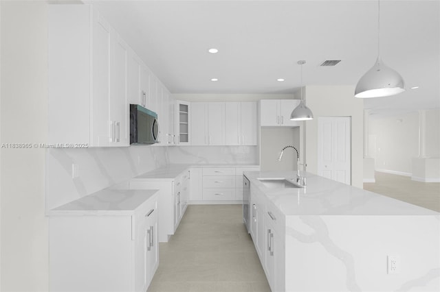 3451 SW 19th St, Fort Lauderdale, FL 33312 - kitchen featuring white cabinets, recessed lighting, glass insert cabinets, tasteful backsplash, and a spacious island
