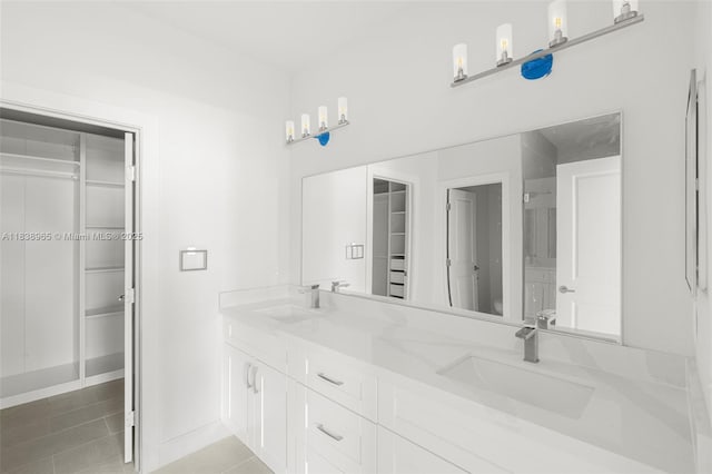 3451 SW 19th St, Fort Lauderdale, FL 33312 - bathroom featuring double vanity, a spacious closet, and tile patterned flooring
