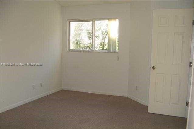 3421 NW 44th St Unit 103, Oakland Park, FL 33309 - unfurnished room with baseboards