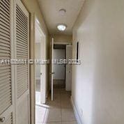 3421 NW 44th St Unit 103, Oakland Park, FL 33309 - hall with tile patterned floors and baseboards