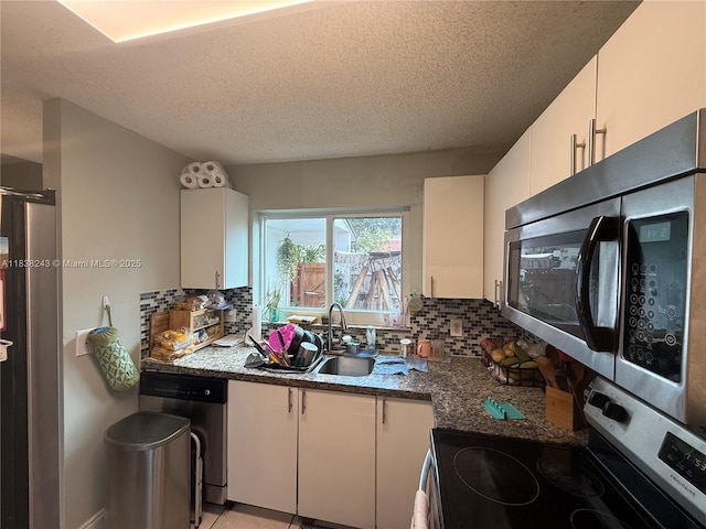 10726 SW 147th Pl, Miami, FL 33196 - kitchen with stainless steel appliances, tasteful backsplash, white cabinetry, and a textured ceiling