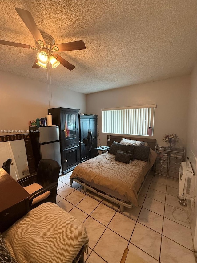 10726 SW 147th Pl, Miami, FL 33196 - bedroom with freestanding refrigerator, light tile patterned floors, a textured ceiling, and ceiling fan