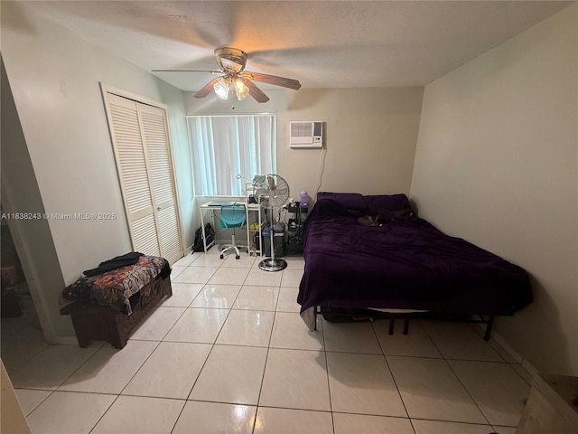 10726 SW 147th Pl, Miami, FL 33196 - bedroom featuring a wall unit AC, ceiling fan, a closet, and light tile patterned floors