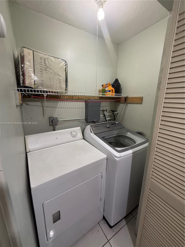 10726 SW 147th Pl, Miami, FL 33196 - laundry area with washing machine and clothes dryer, light tile patterned floors, and a textured ceiling