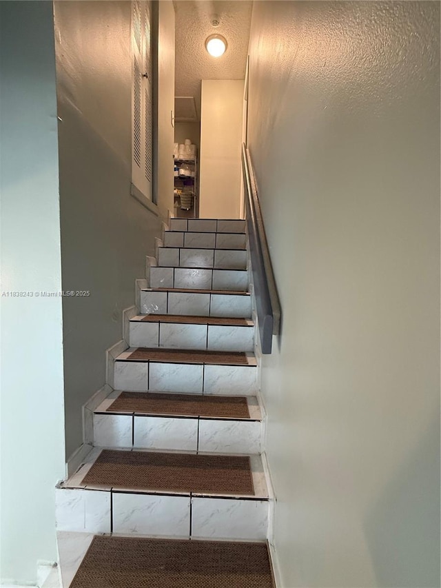 10726 SW 147th Pl, Miami, FL 33196 - stairway with a textured ceiling and baseboards