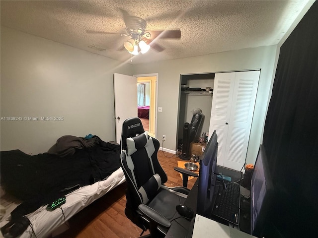 10726 SW 147th Pl, Miami, FL 33196 - bedroom with wood finished floors, a closet, a textured ceiling, and ceiling fan