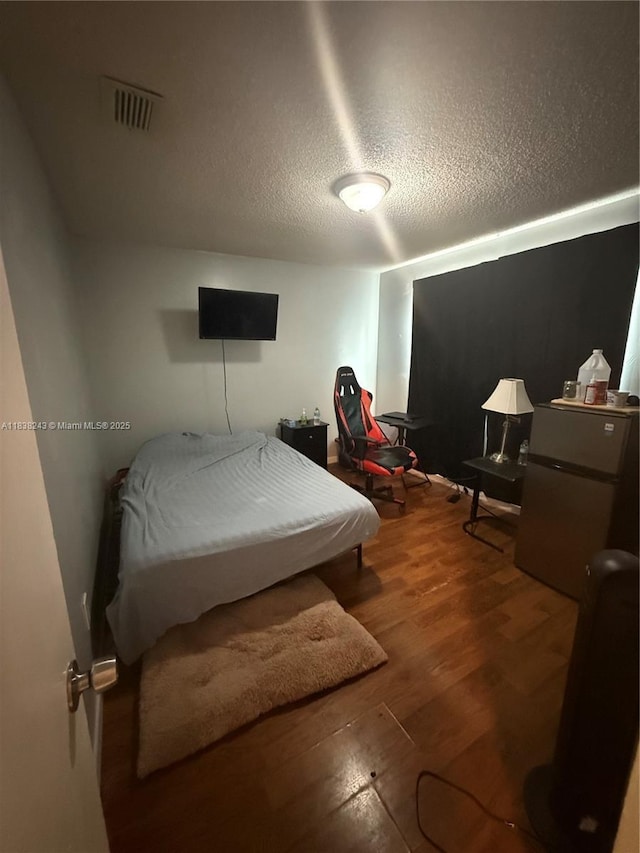10726 SW 147th Pl, Miami, FL 33196 - bedroom featuring wood finished floors and a textured ceiling