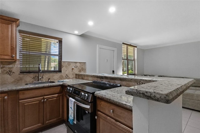 2400 NE 10th St Unit 104, Pompano Beach, FL 33062 - kitchen with stainless steel electric stove, light tile patterned floors, a peninsula, open floor plan, and ornamental molding