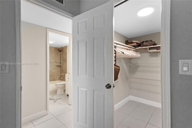 2400 NE 10th St Unit 104, Pompano Beach, FL 33062 - walk in closet featuring light tile patterned floors