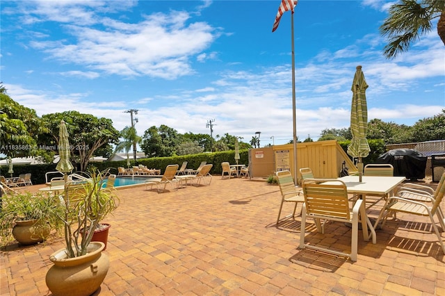 2400 NE 10th St Unit 104, Pompano Beach, FL 33062 - view of patio / terrace with a community pool, outdoor dining space, and a grill