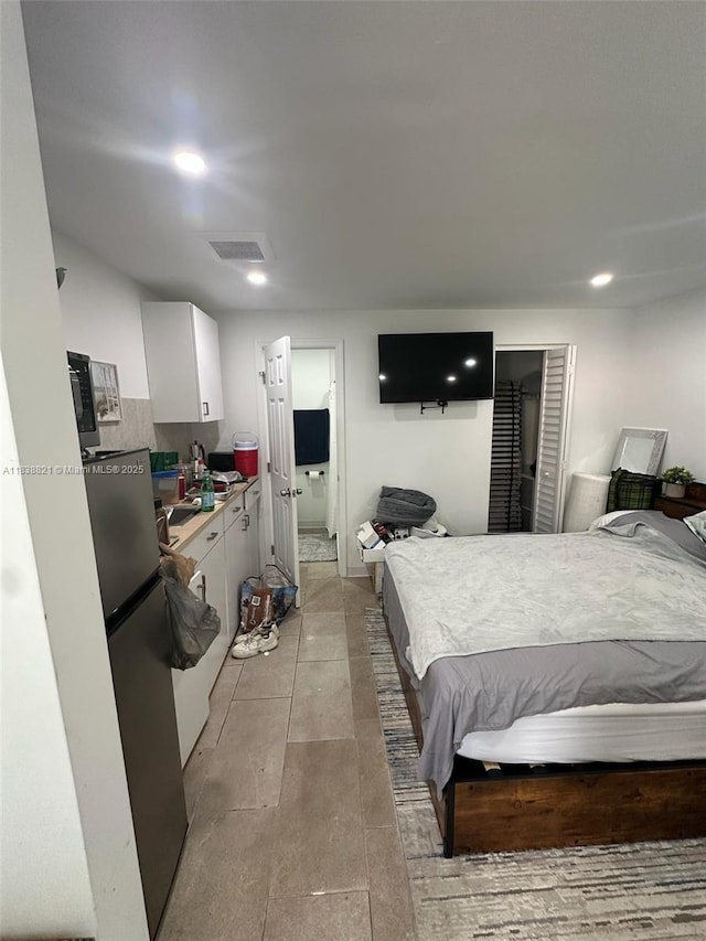 1249 S Flamingo Rd, Davie, FL 33325 - bedroom featuring freestanding refrigerator, light tile patterned floors, and recessed lighting